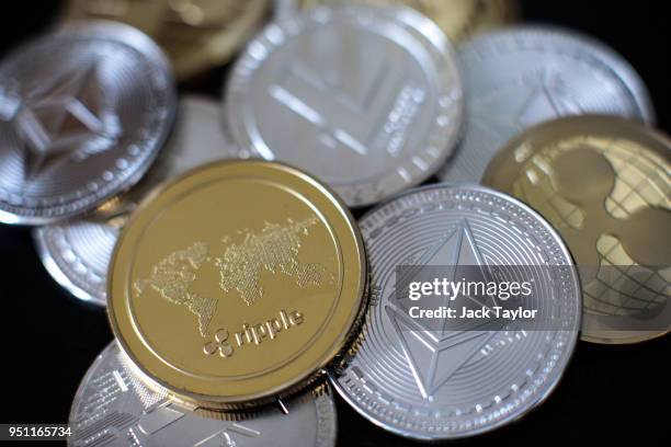 In this photo illustration of the litecoin, ripple and ethereum cryptocurrency 'altcoins' sit arranged for a photograph on April 25, 2018 in London,...