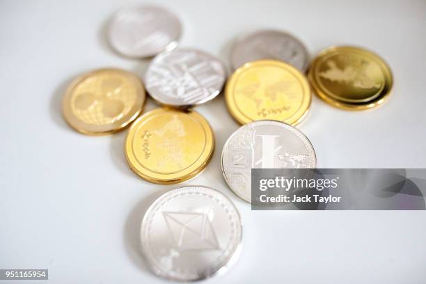 In this photo illustration of the litecoin, ripple and ethereum cryptocurrency 'altcoins' sit arranged for a photograph on April 25, 2018 in London,...