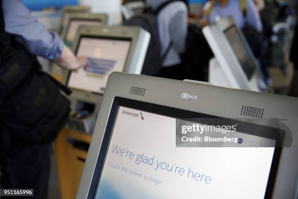 Traveler uses an American Airlines Group Inc. Self check-in kiosk at Los Angeles International Airport in Los Angeles, California, U.S., on Thursday,...