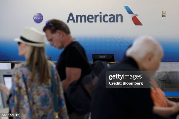 American Airlines Group Inc. Signage is displayed as travelers check-in at Dallas-Fort Worth International Airport in Grapevine, Texas, U.S., on...