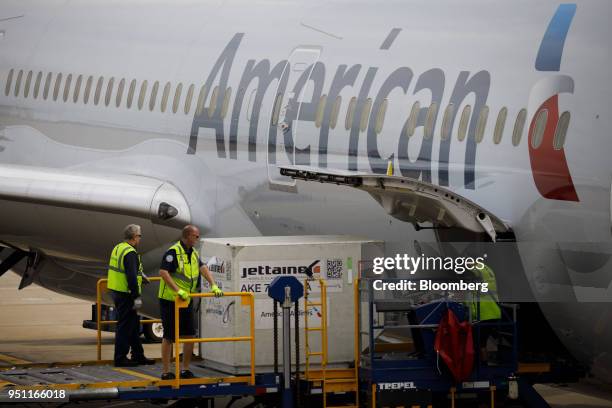 Cargo is loaded onto an American Airlines Group Inc. Plane at Dallas-Fort Worth International Airport in Grapevine, Texas, U.S., on Friday, April 6,...