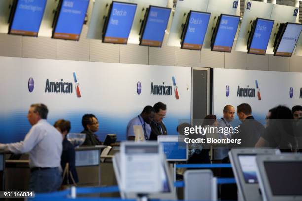 American Airlines Group Inc. Signage is displayed as employees check-in travelers at Dallas-Fort Worth International Airport in Grapevine, Texas,...