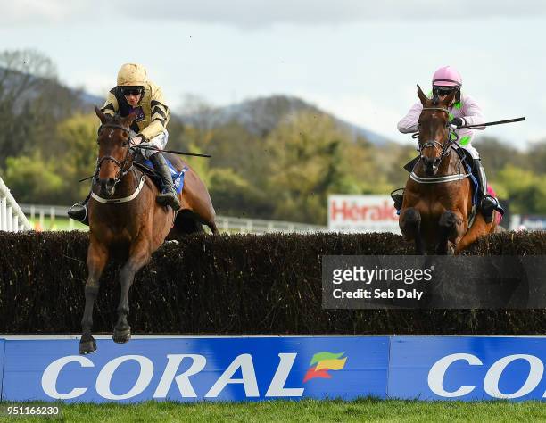 Naas , Ireland - 25 April 2018; Bellshill, left, with David Mullins up, jumps the last alongside Djakadam, right, with Patrick Mullins up, on their...