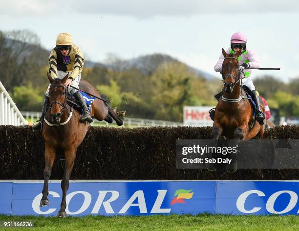 Naas , Ireland - 25 April 2018; Bellshill, left, with David Mullins up, jumps the last alongside Djakadam, right, with Patrick Mullins up, on their...