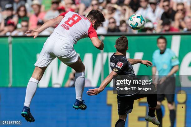 Rani Khedira of Augsburg and Pablo de Blasis of Mainz battle for the ball during the Bundesliga match between FC Augsburg and 1. FSV Mainz 05 at...