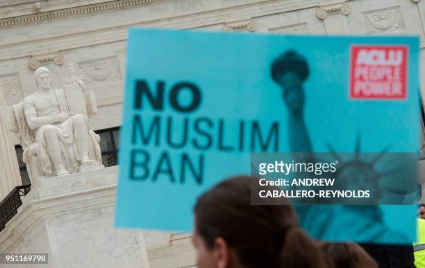 Activists rally against the Muslim Ban on the day the Supreme Court hears arguments in Hawaii v. Trump in front of the court in Washington, DC on...