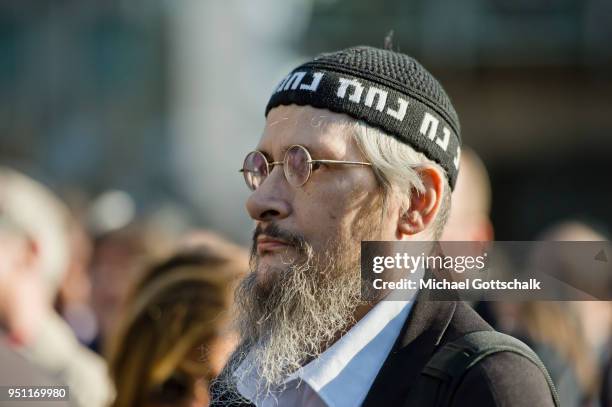 Activists holding a banner with the words "Against any kind of anti-Semitism" attend a "wear a kippah" gathering to protest against anti-Semitism in...