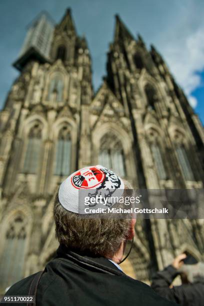 An activist wearing a kippah with a logo of Cologne soccer club 1. FC Koeln attends a "wear a kippah" gathering to protest against anti-Semitism in...
