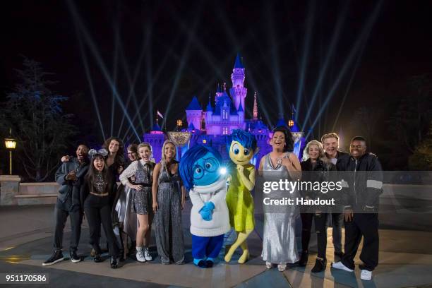 American Idol" Top 10 Contestants pose with Joy and Sadness from the Pixar film, "Inside Out," following a performance in front of Sleeping Beauty...