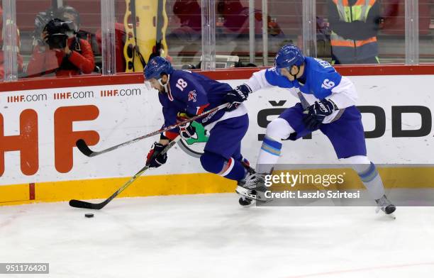 Yaroslav Yevdokimov of Kazakhstan challenges Oliver Betteridge of Great Britain during the 2018 IIHF Ice Hockey World Championship Division I Group A...