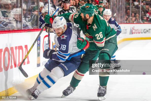 Daniel Winnik of the Minnesota Wild defends Bryan Little of the Winnipeg Jets in Game Four of the Western Conference First Round during the 2018 NHL...