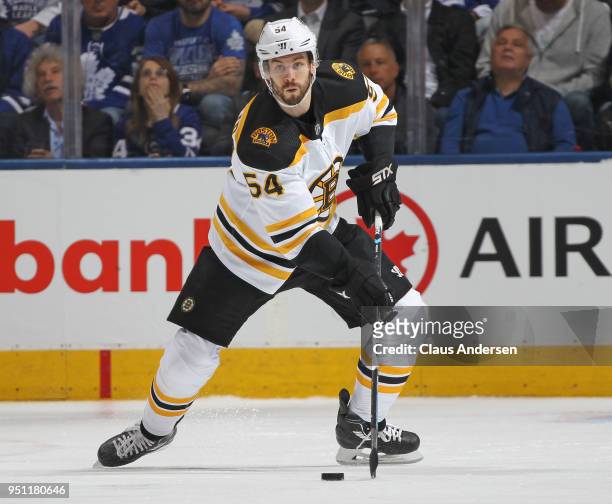 Adam McQuaid of the Boston Bruins skates with the puck against the Toronto Maple Leafs in Game Six of the Eastern Conference First Round in the 2018...