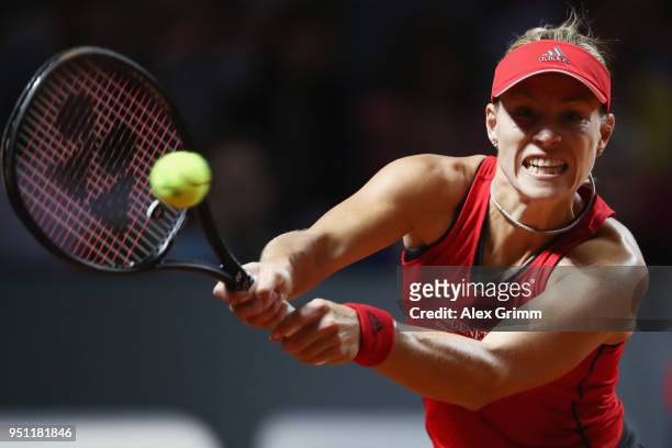 Angelique Kerber of Germany plays a backhand to Petra Kvitova of Czech Republic during day 3 of the Porsche Tennis Grand Prix at Porsche-Arena on...