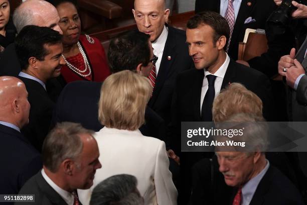 French President Emmanuel Macron greets U.S. Secretary of the Treasury Steven Mnuchin after delivering an address to a joint meeting of U.S. Congress...