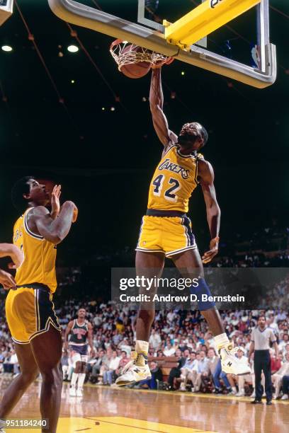 James Worthy of the Los Angeles Lakers dunks the ball against the Phoenix Suns on December 15, 1987 at The Forum in Inglewood, California. NOTE TO...