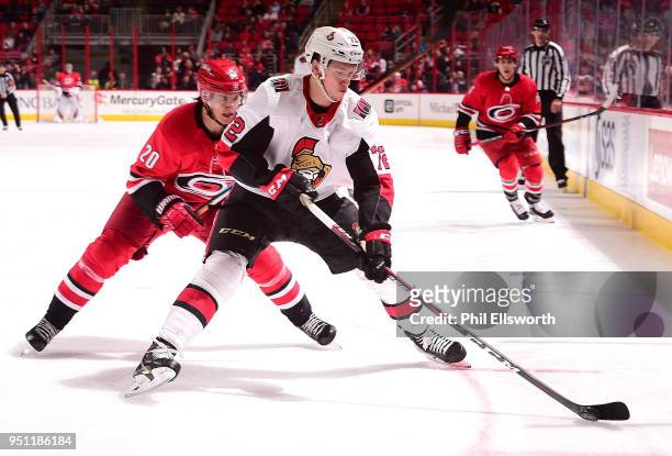 Thomas Chabot of the Ottawa Senators keeps the puck from Sebastian Aho of the Carolina Hurricanes during an NHL game on March 26, 2016 at PNC Arena...