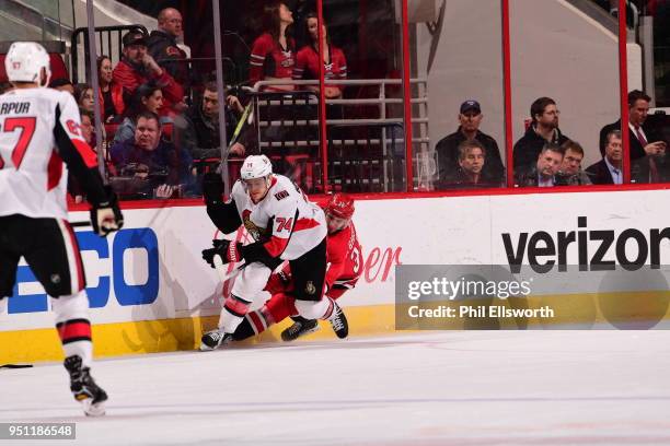 Mark Borowiecki of the of the Ottawa Senators battles along the boards with Phillip Di Giuseppe of the Carolina Hurricanes during an NHL game on...