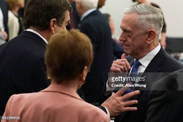 Secretary of Defense Jim Mattis talks to a committee member prior to a closed hearing before the Defense Subcommittee of the House Appropriations...