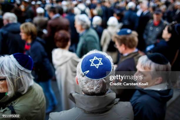 Participants wearing a kippah during a "wear a kippah" gathering to protest against anti-Semitism in front of the Jewish Community House on April 25,...