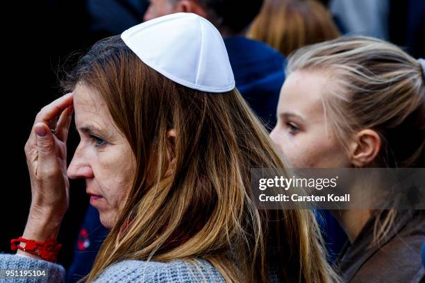 Participants wearing a kippah during a "wear a kippah" gathering to protest against anti-Semitism in front of the Jewish Community House on April 25,...