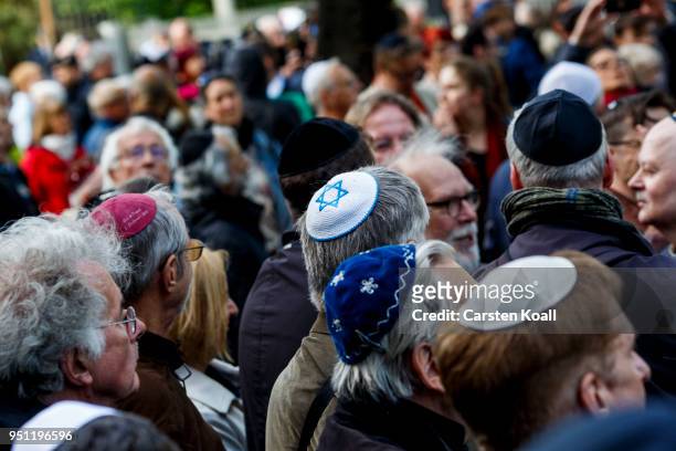 Participants wearing a kippah during a "wear a kippah" gathering to protest against anti-Semitism in front of the Jewish Community House on April 25,...