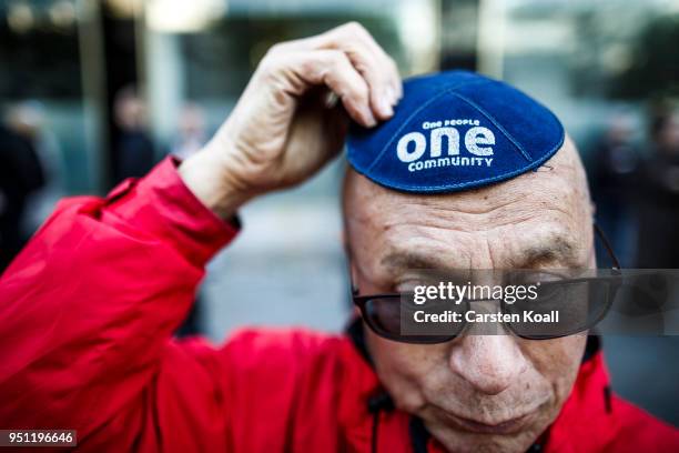 Participant wears a kippah during a "wear a kippah" gathering to protest against anti-Semitism in front of the Jewish Community House on April 25,...