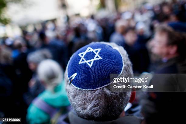 Participant wears a kippah during a "wear a kippah" gathering to protest against anti-Semitism in front of the Jewish Community House on April 25,...