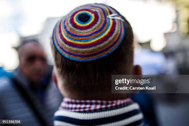 Participant wears a kippah during a "wear a kippah" gathering to protest against anti-Semitism in front of the Jewish Community House on April 25,...