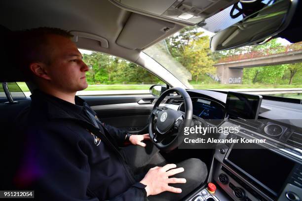 Test driver rests his hands as artificial intelligence takes over driving the car during tests of autonomous car abilities conducted by Continental...