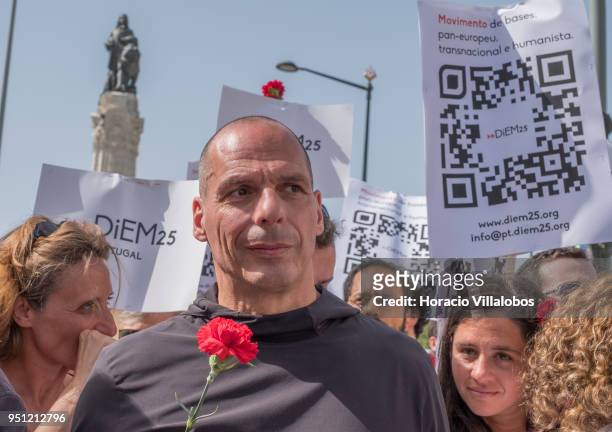 Former Greek Finance Minister and co-founder of DiEM25 Yanis Varoufakis holds a red carnation before walking through Avenida da Liberdade with...