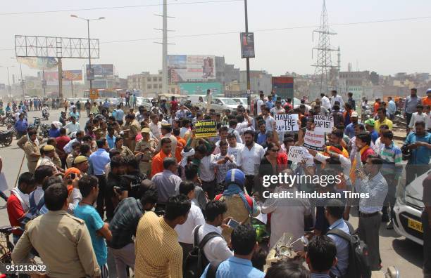 Locals and members of saffron outfits block NH-24 during their protest demanding arrest of cleric of madrasa in a rape case of a minor on April 25,...