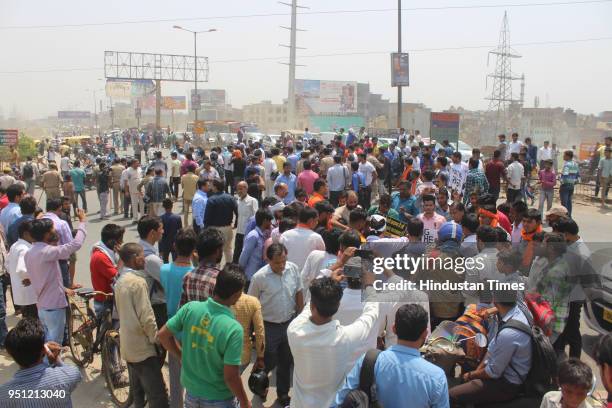 Locals and members of saffron outfits block NH-24 during their protest demanding arrest of cleric of madrasa in a rape case of a minor on April 25,...