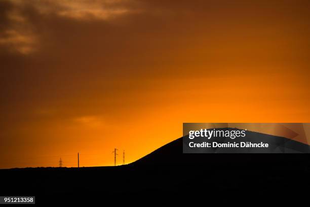 mountain silhouette at sunset - dähncke stock pictures, royalty-free photos & images