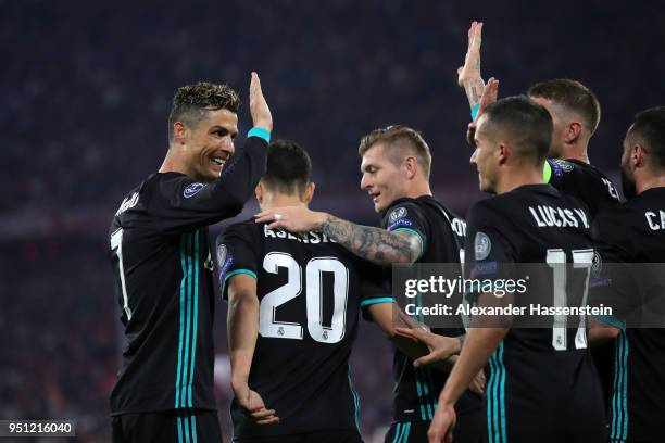 Cristiano Ronaldo and Toni Kroos congratulate Marco Asensio of Real Madrid on scoring his sides second goal during the UEFA Champions League Semi...