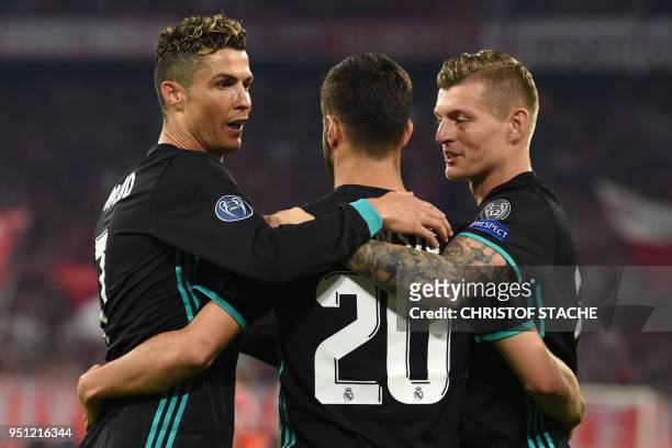 Real Madrid's Spanish midfielder Marco Asensio celebrates with Real Madrid's Portuguese forward Cristiano Ronaldo and Real Madrid's German midfielder...