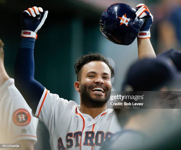 Jose Altuve of the Houston Astros celebrates by himself in the dugout after hitting a home run against the Los Angeles Angels of Anaheim in the sixth...