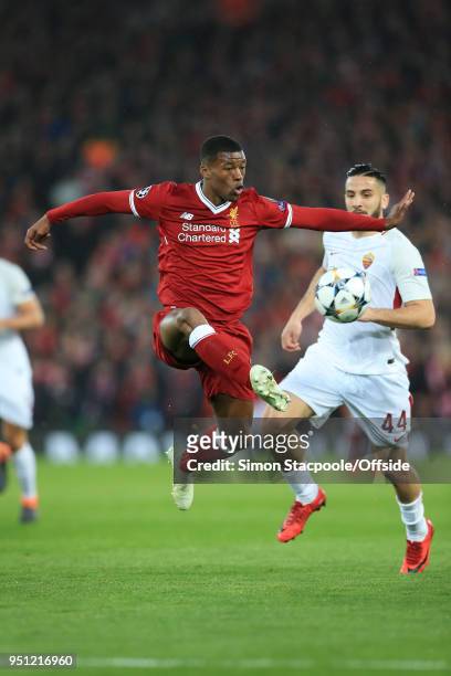 Georginio Wijnaldum of Liverpool leaps to control the ball under pressure from Konstantinos Manolas of Roma during the UEFA Champions League Semi...