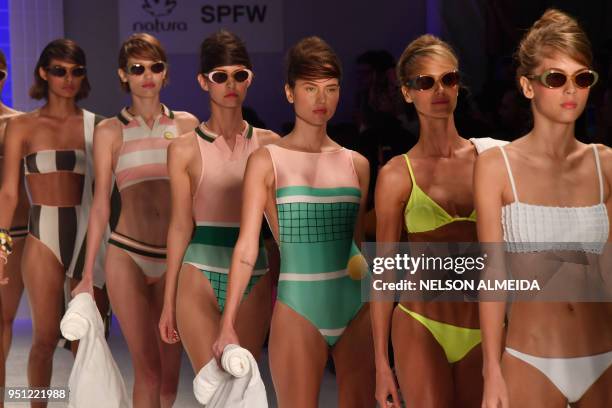 Models present creations by Salinas during the Sao Paulo Fashion Week in Sao Paulo, Brazil on April 25, 2018.