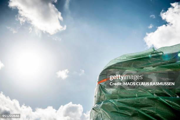 Picture taken on April 25, 2018 shows a detail of the homemade submarine UC3 Nautilus as it is covered with green tarpaulin in Nordhavn, a harbour...