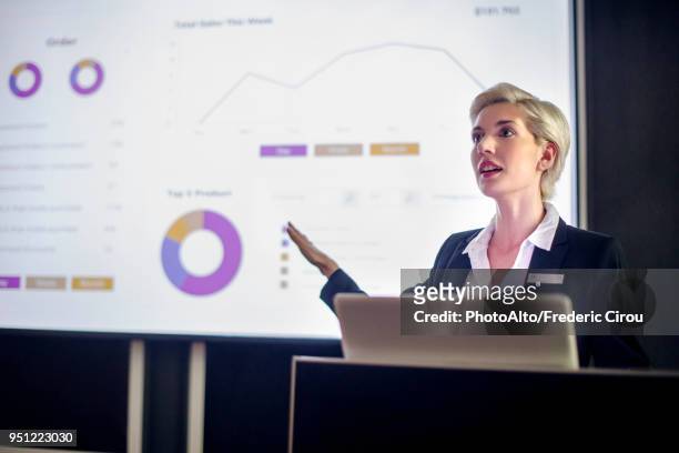 woman giving presentation - multimedia presentation stock pictures, royalty-free photos & images