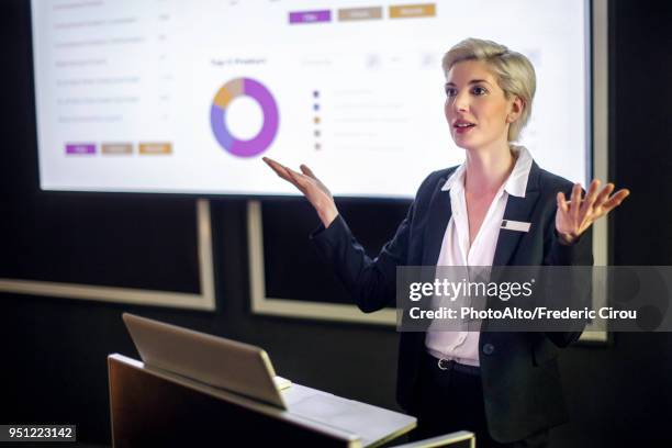 woman giving presentation - multimedia presentation stock pictures, royalty-free photos & images