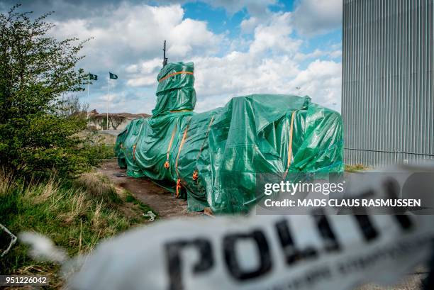 Picture taken on April 25, 2018 shows the homemade submarine UC3 Nautilus as it is covered with green tarpaulin in Nordhavn, a harbour area in...