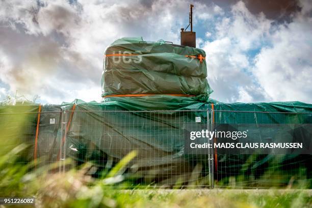 Picture taken on April 25, 2018 shows the homemade submarine UC3 Nautilus as it is covered with green tarpaulin in Nordhavn, a harbour area in...