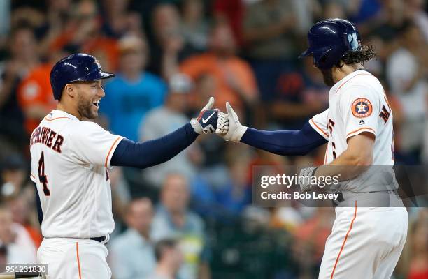 George Springer of the Houston Astros congratulates Jake Marisnick after his home run against the Los Angeles Angels of Anaheim in the seventh inning...
