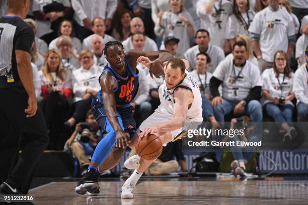 Joe Ingles of the Utah Jazz handles the ball against Jerami Grant of the Oklahoma City Thunder in Game Four of Round One of the 2018 NBA Playoffs on...