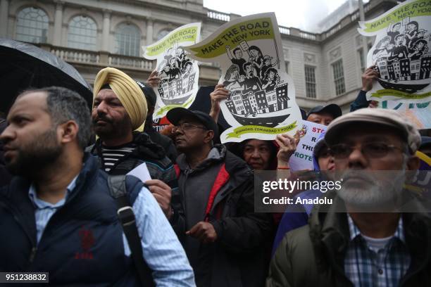 Families of yellow cab drivers hold banners demanding protection of full-time jobs during a rally in New York City after New York Taxi Workers...