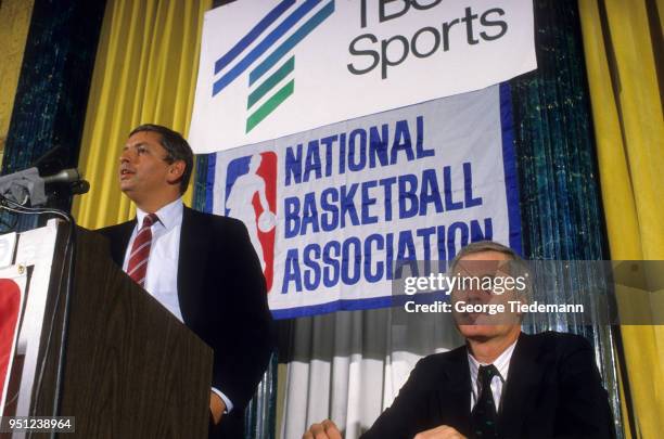 Commissioner David Stern at podium with Ted Turner sitting beside him during press conference announcing Rick Barry and Bill Russell as the new play...