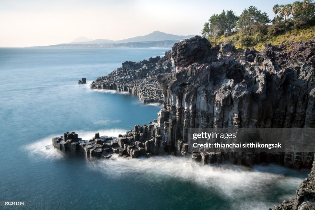 Landscape of cliff and white of wave at jeju island