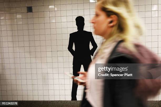 Pictures of rock legend Davis Bowie line the walls of a New York City subway station on April 25, 2018 in New York City. Besides concert photos and...