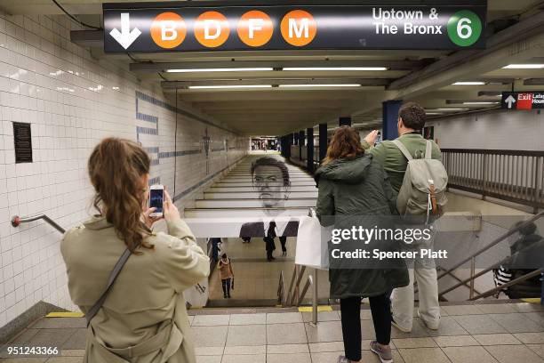 Pictures of rock legend Davis Bowie line the walls of a New York City subway station on April 25, 2018 in New York City. Besides concert photos and...